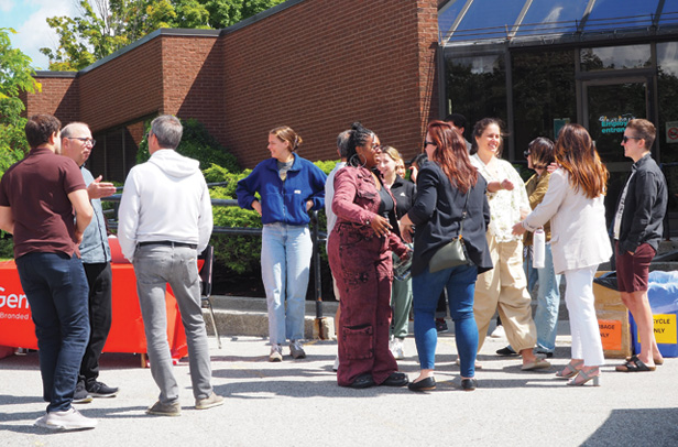 group of people talking outside office building