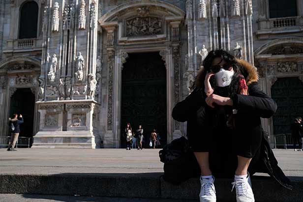 People wear facemasks in Milan