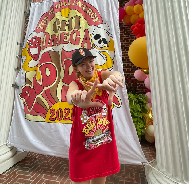 sorority girl standing in front of banner