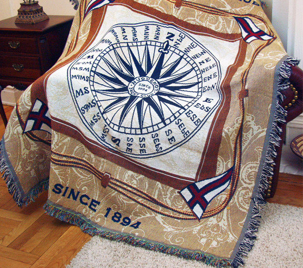 Woven blanket with compass design and fringed edges