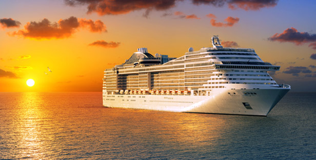 Cruise ship on ocean at sunset