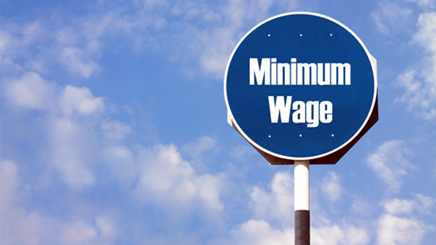 Minimum wage sign against blue sky