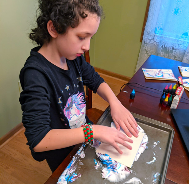 Young girl making art project