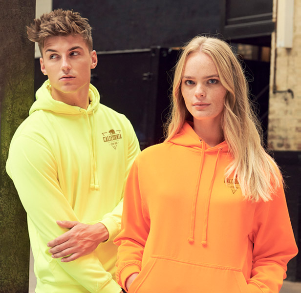 man and woman wearing yellow and orange sweatshirt