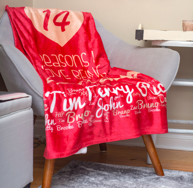 red full-color print throw blanket on gray chair