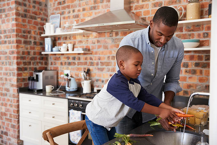 Young father and son preparing dinner