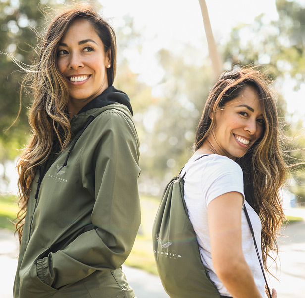 woman wearing sage green packable windbreaker