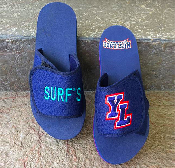 blue sandal flops with embroidery on top