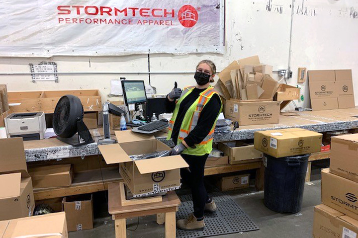 woman giving thumbs up inside Stormtech warehouse