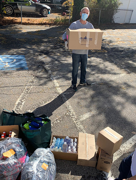 volunteer holding box of donations