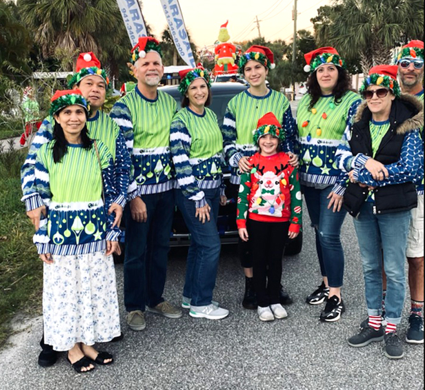 Children's World employees showing off ugly holiday sweaters