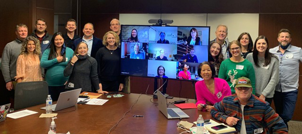 Image Source staff in conference room, virtual meeting in background