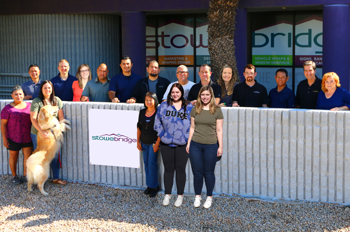 Stowebridge employees posing in front of building