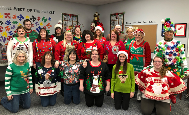 Employees wearing their ugly holiday sweaters