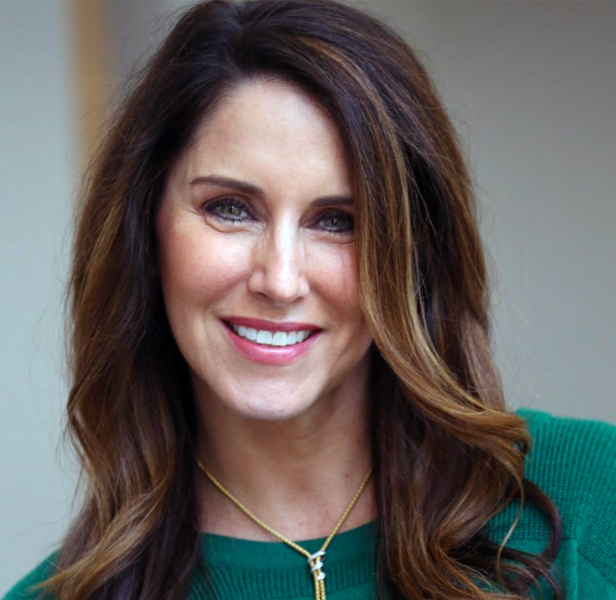 Liz Sachs, woman smiling, green sweater