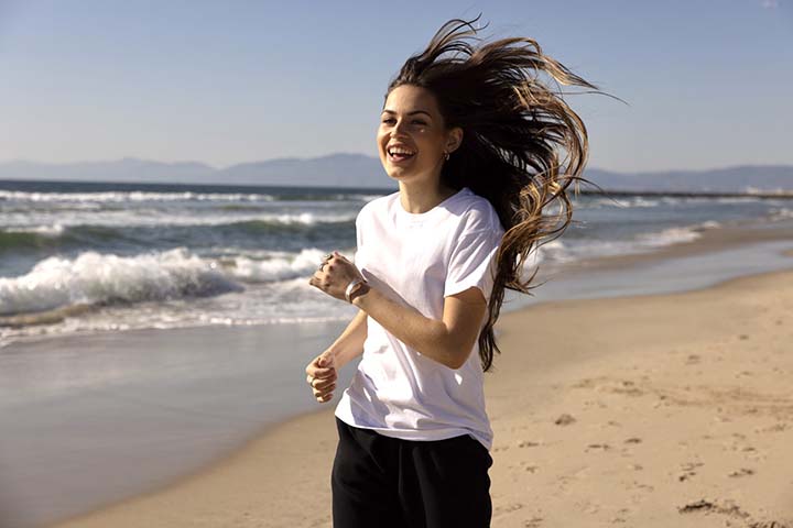 Young woman running on the beach