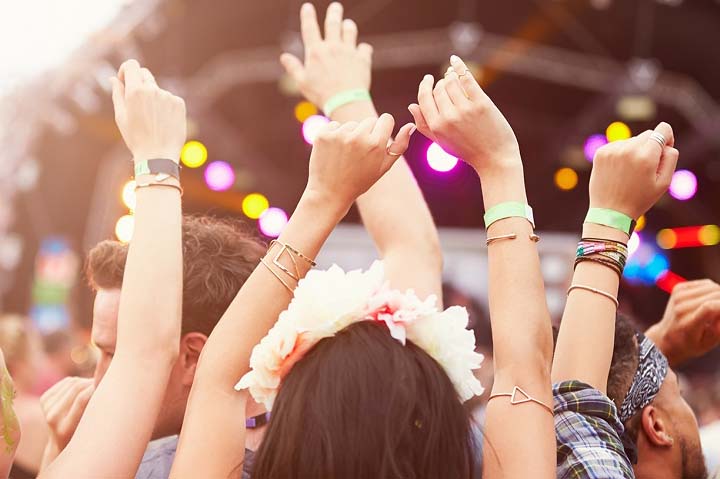 Young people at a festival with bracelets on