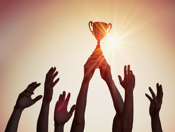 winning-team-holding-trophy-hands-silhouettes