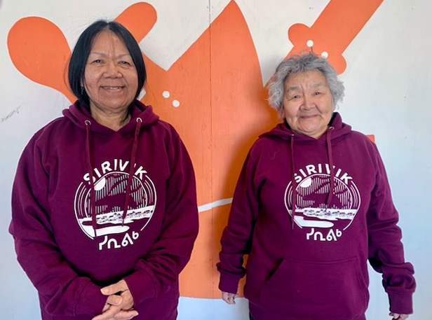 two women wearing sweatshirts