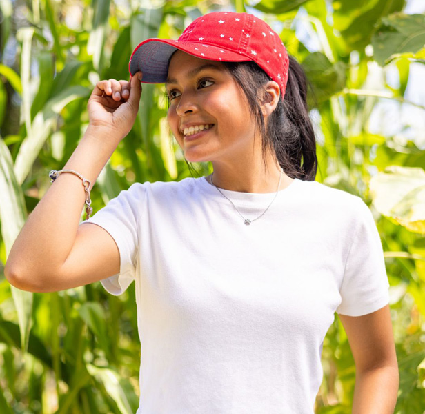 woman wearing white tee and red cap with white stars