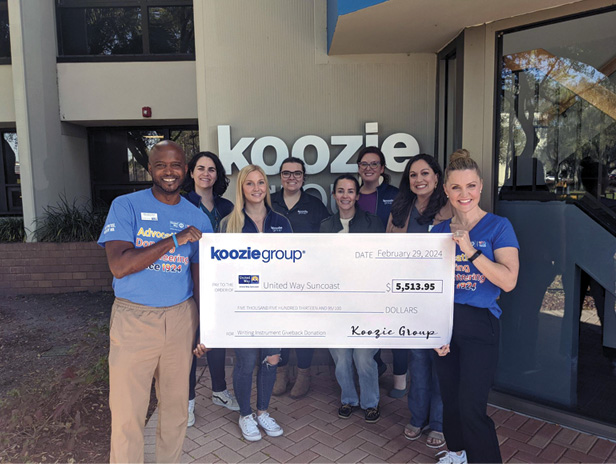 Koozie employees holding large check from United Way