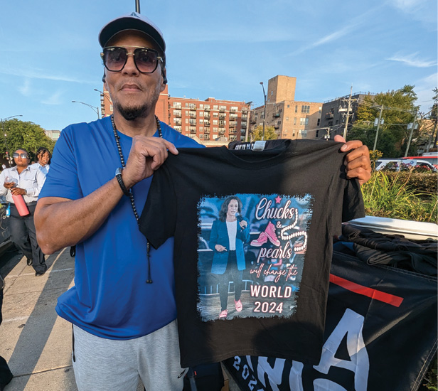 DNC merch vendor holding up tee