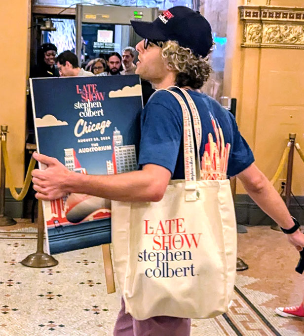 DNC goer carrying Colbert Late show tote bag