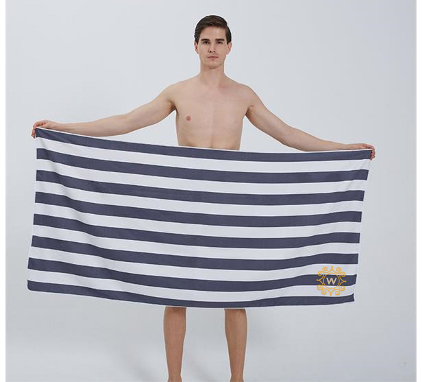 man holding beach towel