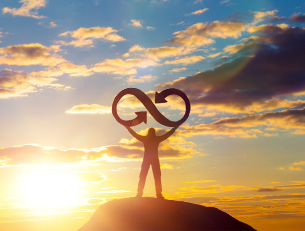 man holding infinity symbol on mountain