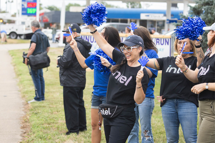 people cheering with pom poms and noise makers