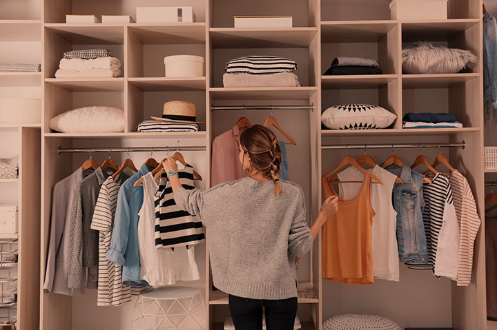 woman looking through closet