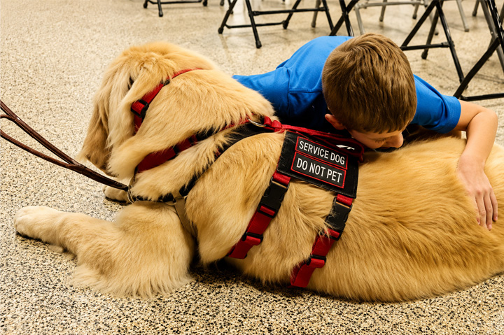 Family Welcomes Service Dog Through 4 Paws for Ability With Support From Koozie Group